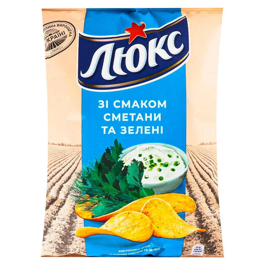 Картопляні чіпси Люкс 125 г зі смаком сметани та зелені, синьо-бежева пачка з чіпсами й соусом